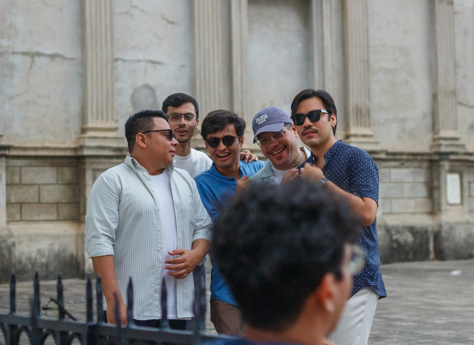 A group of men standing together and smiling for a photo
